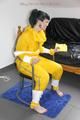 Jill tied and gagged on a chair wearing a yellow rainsuit and coveres with an yellow raincoat with two hoods (Pics)