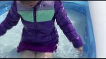 Watching Mara wearing a sexy short down skirt and a down jacket playing with water in the swimming pool (Video)