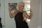 Blonde mature Claudia stipping out of a black dress