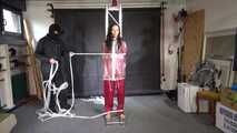 Ayana in a shiny nylon red rainsuit and a see through PVC Rainjacket, tied gagged, hooded and vibed