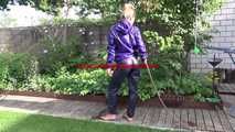 Watching sexy Sandra wearing a sexy blue rain pants and a purple rain jacket watering the flowers in the garden (Video)