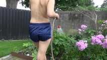 Watching Ayiana wearing  only a sexy blue shiny nylon shorts watering the flowers (Video)