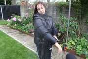 Watching Aiyana wearing a sexy black shiny nylon rainpant and a black shiny nylon down jacket trying the garden shower  (Pics)