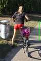 Watch Sandra riding her bike enjoying her red shiny nylon Shorts