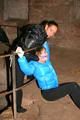 One archive girl tied and gagged by another archive girl outdoor wearing lightblue and black shiny downjackets (Pics)