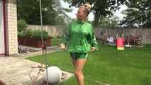 Watching sexy Sandra wearing a sexy green shiny nylon shorts and a green shiny nylon rain jacket enjoying the garden shower (Video)