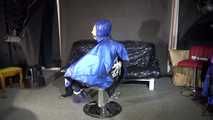 Watching sexy Sandra wearing a sexy blue shiny nylon rainpants and a blue down jacket being tied and gagged and hooded with ropes on a hairdressers chair covered with a rain cape (Video)