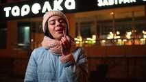 Lovely Russian girl Karina smokes a cigarette in the cold outside 