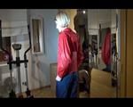 Watch Sonja to dress herself with rainwear and begin her workout on the home trainer (Video)