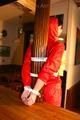 Jill tied and gagged on a pillar wearing a shiny red rainwear (Pics)