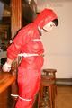 Jill tied and gagged on a pillar wearing a shiny red rainwear (Pics)