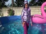 Watch Sandra enjoying her shiny nylon Downwear at a warm Summer Day in the Garden and in the Pool