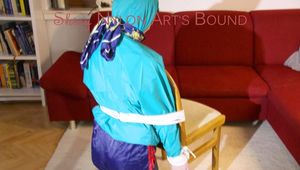 Mara tied and gagged and hooded on a chair wearing sexy shiny nylon shorts over a rainpants and a rain jacket (Pics)