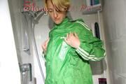 Sonja oiling and rinsing herself in the shower wearing a supersexy green shiny nylon shorts and rain jacket (Pics)