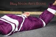 Sexy Sandra being tied, gagged and hooded with tape on the floor wearing a supersexy purple rain overall (Pics)