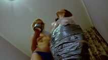 Dana and Mishel - Dana is mummified, hogtaped and teased by Mishel