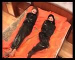 [From archive] Marvita and Chantelle are mummified in black cling film on the bed (video)