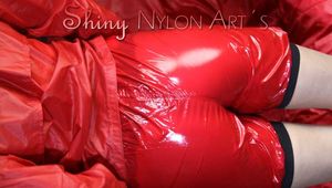 Watching sexy Sandra during her selfbondage action with cuffs in a red shiny nylon Crazy Sensations Chillshorty and a shiny nylon rain jacket in red (www.crazysensations.com). Buy the original Short (used) from us.