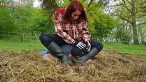 Rubber boot mistress presses slave face into manure