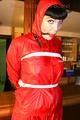 Jill tied and gagged on a pillar wearing a shiny red rainwear (Pics)