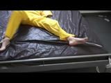 Pia tied and gagged in an yellow rainsuit on bed (Video)