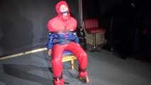 Sandra wearing a sexy OLDSCHOOL shiny nylon downsuit sitting on a chair being tied, gagged and hooded with tension belts and a clothgag (Video)