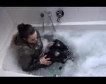 Jill Diamond wearing a supersexy black rain pants and a darkgreen down jacket in the bathtub (Video)