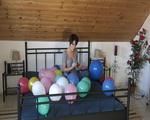 Smoking teen plays with many balloons