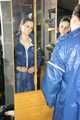 Lucy wearing sexy blue shiny nylon rainwear cleaning the mirror (Pics)