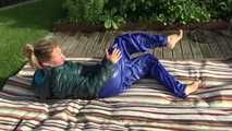 Watching sexy Sandra wearing a sexy blue rainsuit and a green downjacket enjoying the sun and the water in the pool (Video)